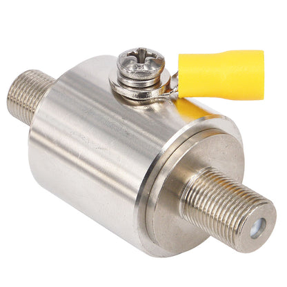 Angled view of a cylindrical silver RF surge protector with threaded ends and yellow-capped ground lug